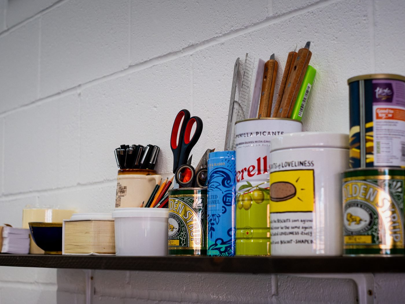 Studio shelf with tools and materials at flood and pull.