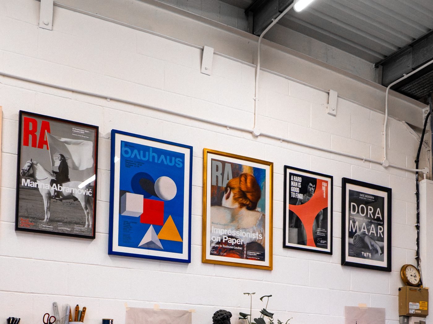 Inside flood and pull. screen print studio, with framed prints on the wall.